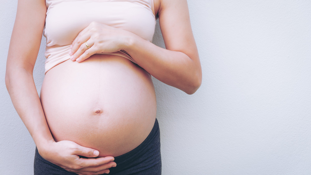 Woman holding her pregnant belly