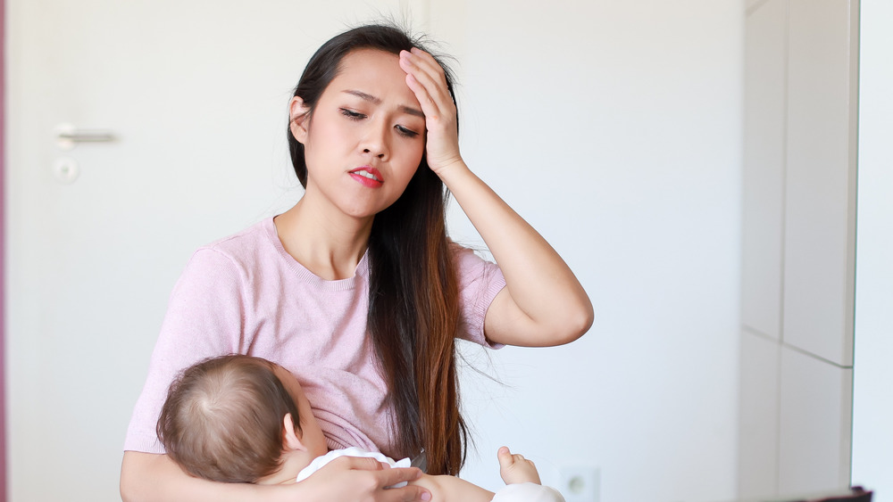 Concerned woman breastfeeding