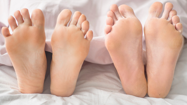 Couple in bed with flexed feet