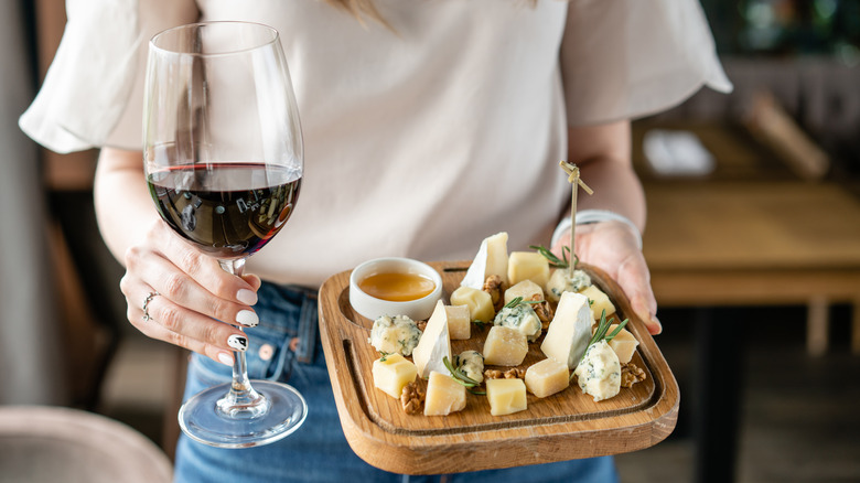 woman holding cheese platter