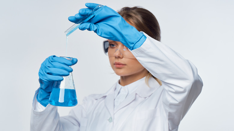 woman with test tube and beaker