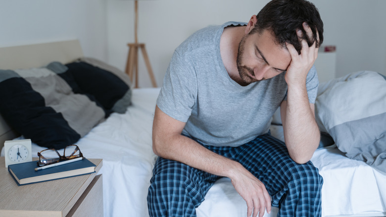 guy sitting on bed