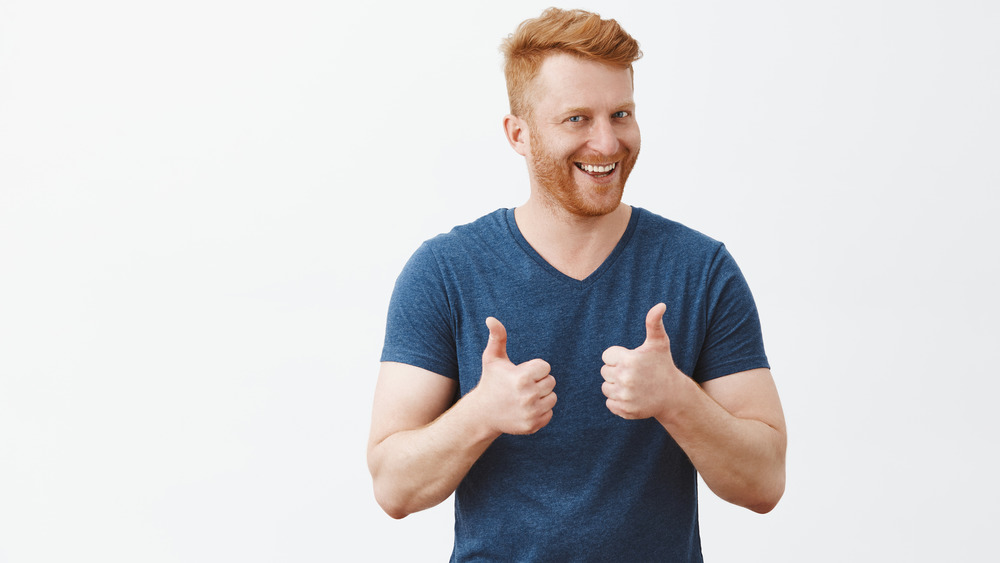 Redheaded man giving a thumbs up