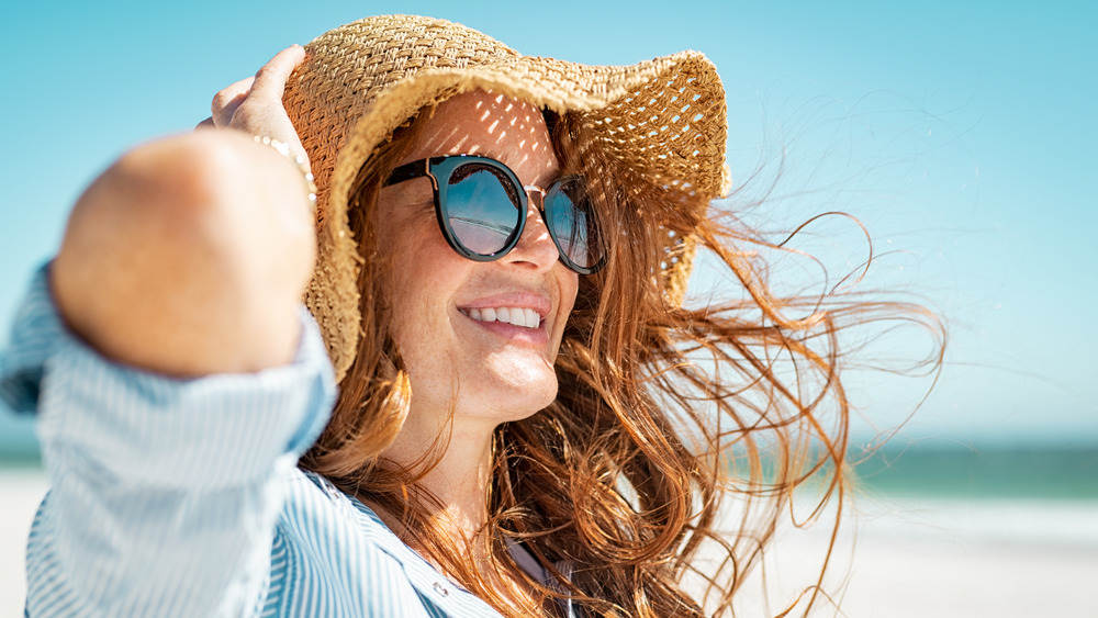 woman with straw hat, smiling