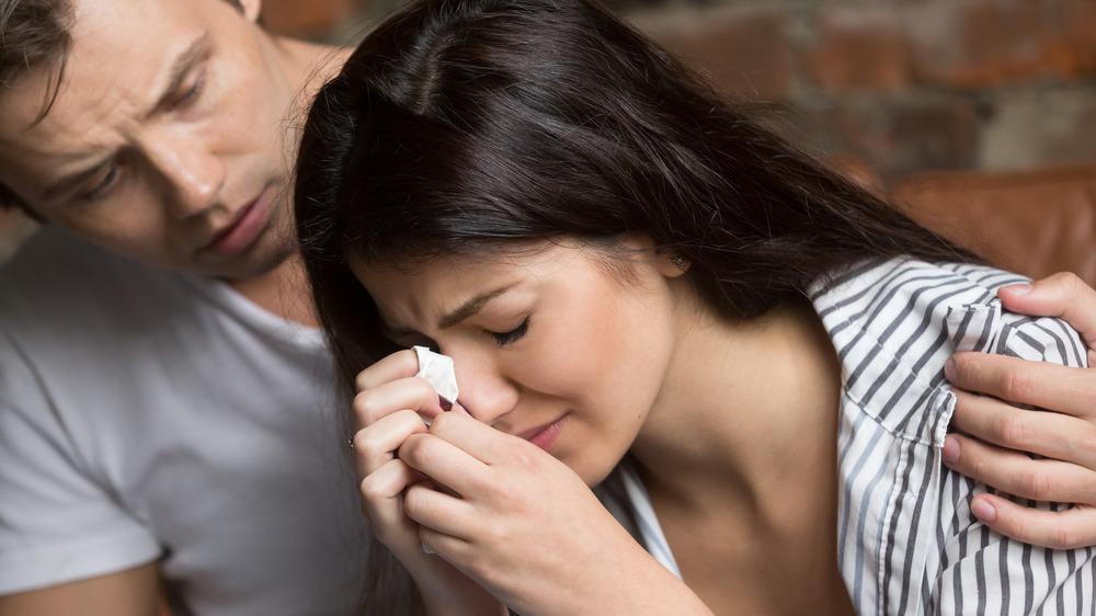 Man Comforting Upset Woman