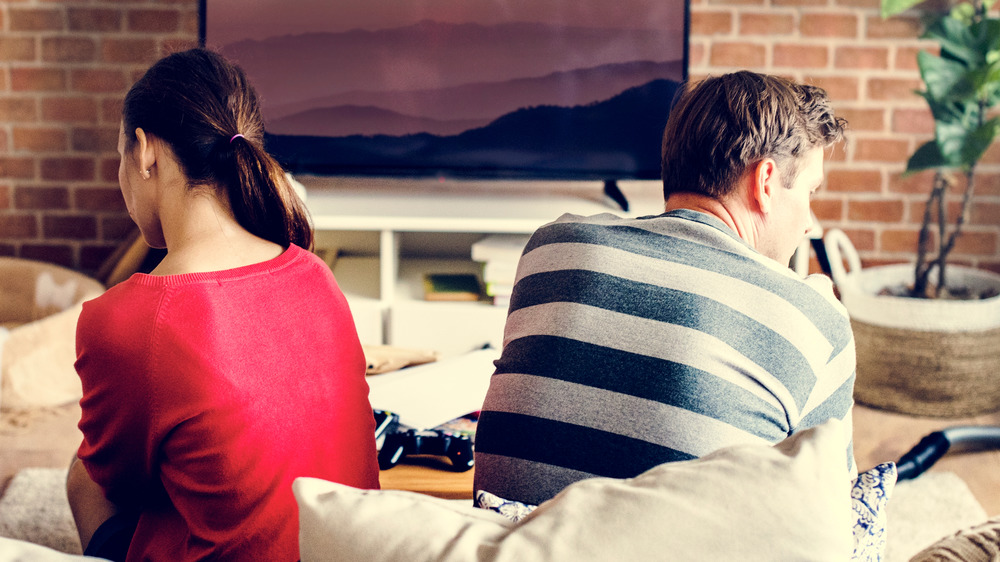 Backs of couple sitting on couch