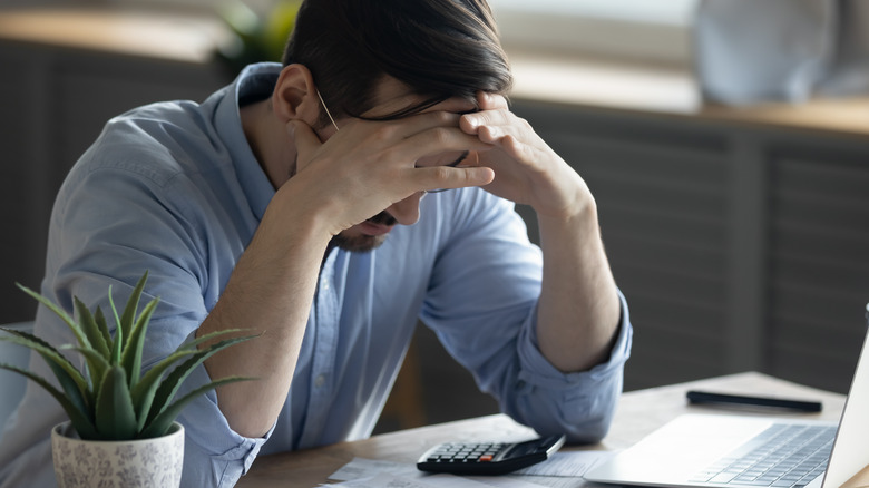 man stressed desk