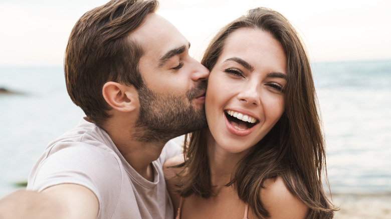 young happy couple smiling outside