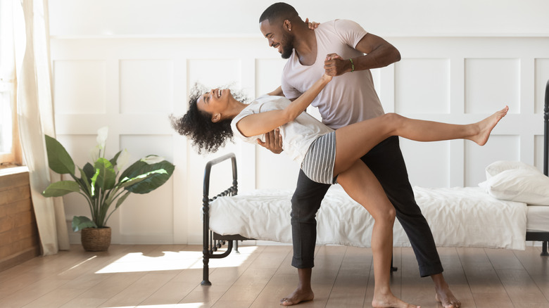 black couple in bedroom dancing
