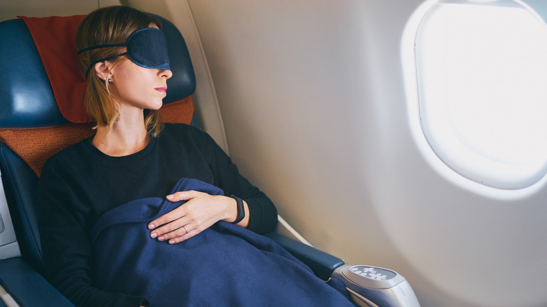 sleeping woman on airplane in first class