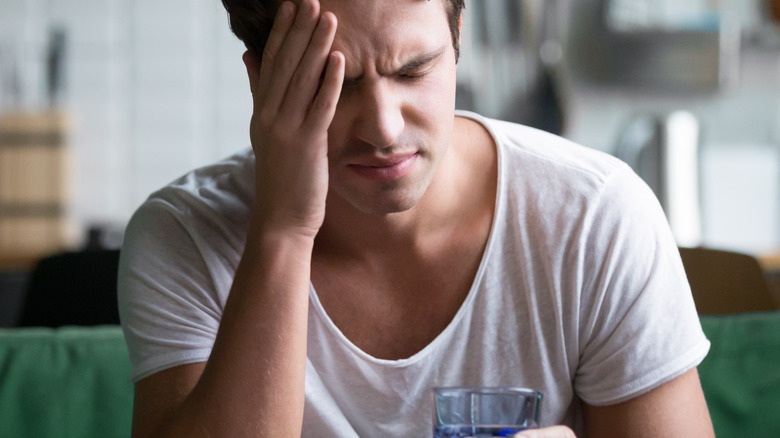 confused man drinking water