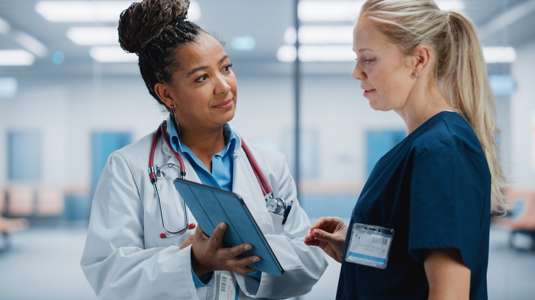 doctor in hospital discussing with nurse