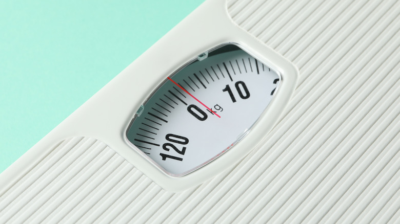 Bathroom scale on a mint background