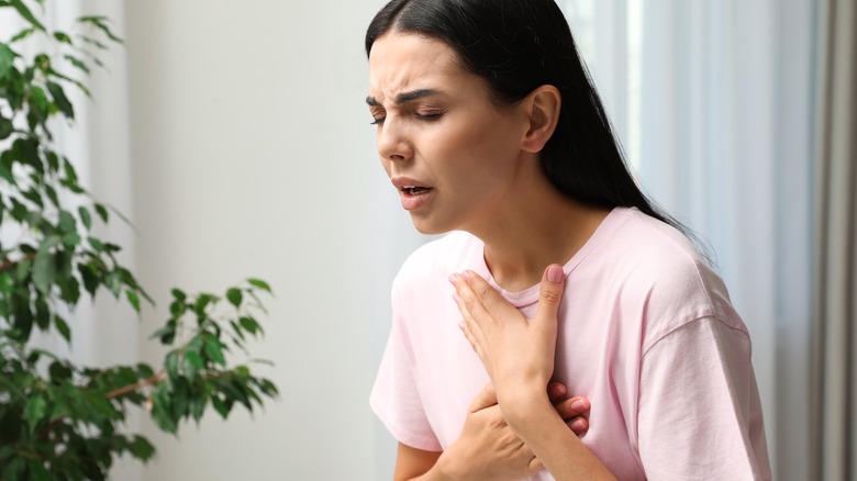 woman with long hair struggling to breathe