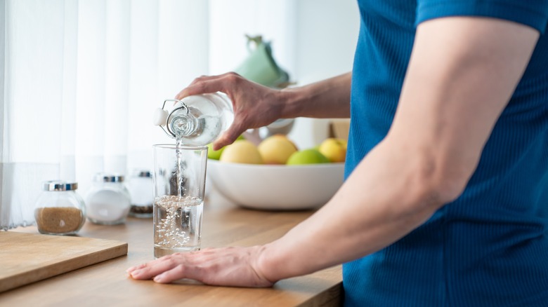 Man pouring glass of water