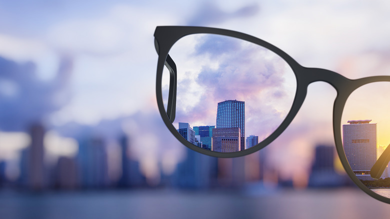 Close up of a pair of glasses where the area of the background seen through the lenses is clear but the rest of the background is blurry