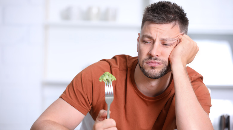 guy not eating broccoli