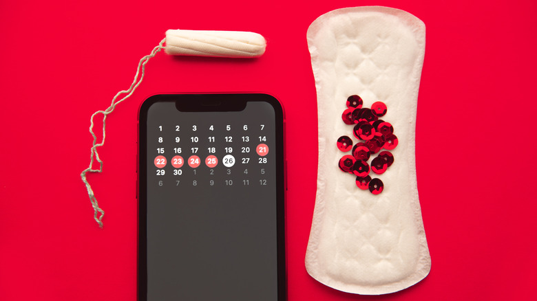 A tampon, a pad, and a period tracking app 