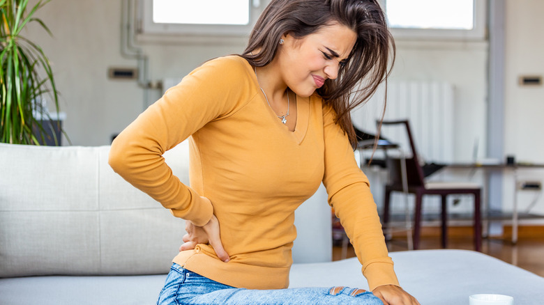 Woman holding back in pain