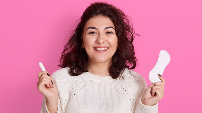 White woman holding a tampon