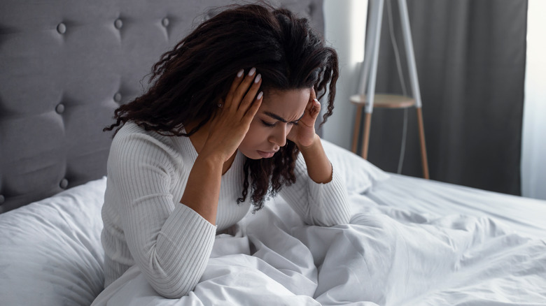 Woman in bed with headache