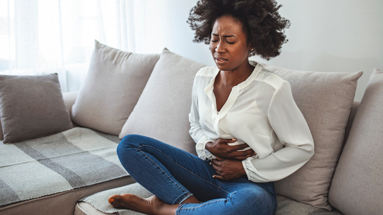 Black woman sitting on a couch