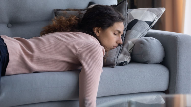 Woman lying on her stomach on a couch