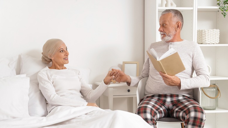 woman holding her husband's hand after chemotherapy