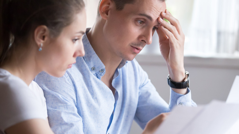 woman and man reading legal papers