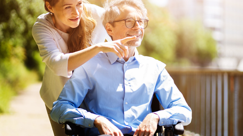 female with elderly male in wheelchair