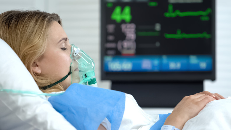 woman in coma with oxygen mask