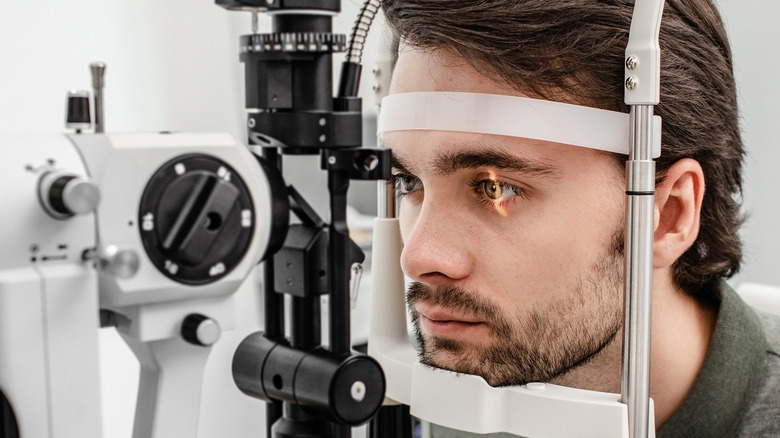 A man with a beard getting an eye exam