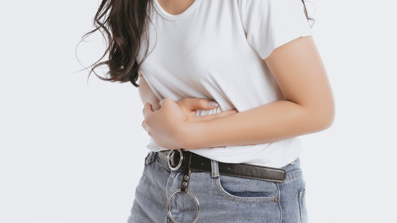 Woman holding her stomach in discomfort