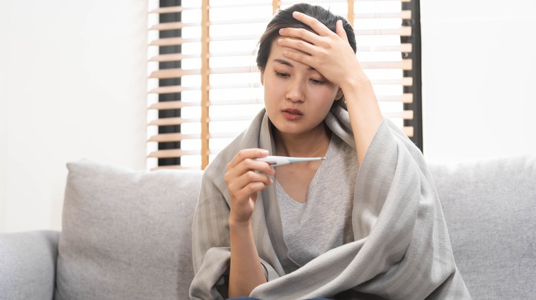 Woman checking her temperature