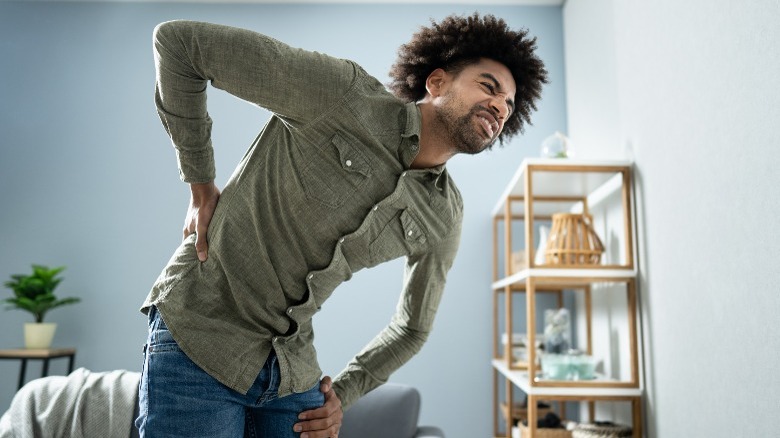 man leaning with back pain