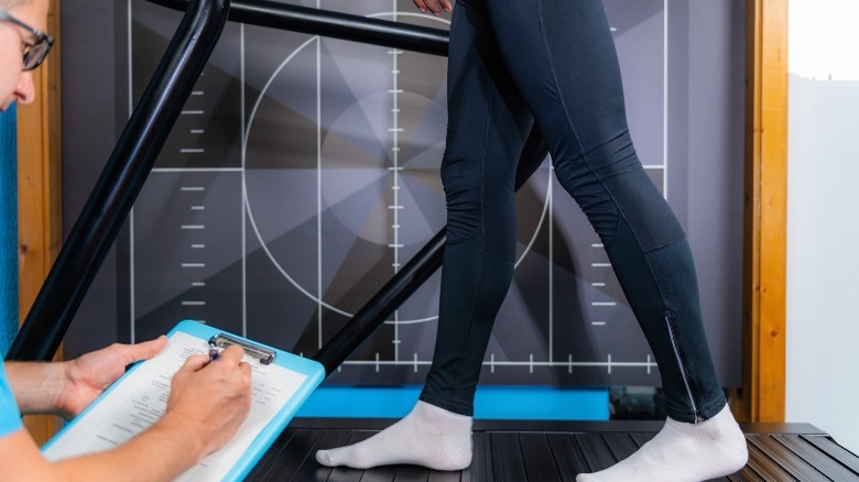 doctor monitoring treadmill gait patterns