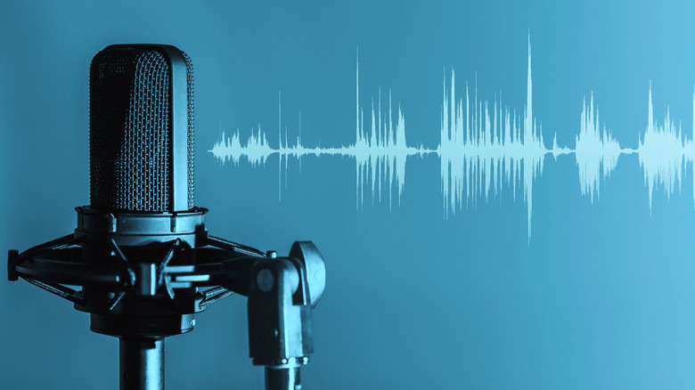 A microphone next to an image of sound waves against a blue background