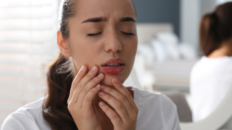 Woman with lip sore