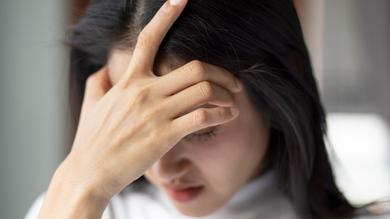 woman having headache hand on forehead