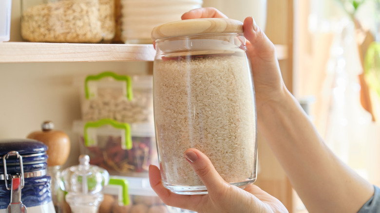 Woman holding container of rice