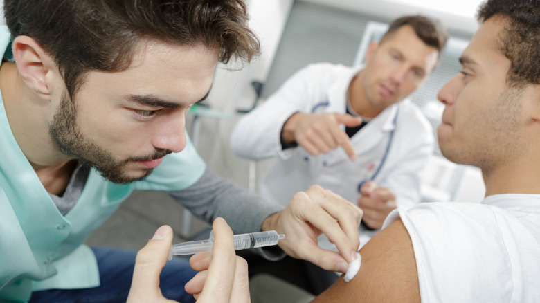 doctor injecting patient's arm