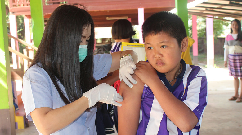 nurse touching fearful kid's arm