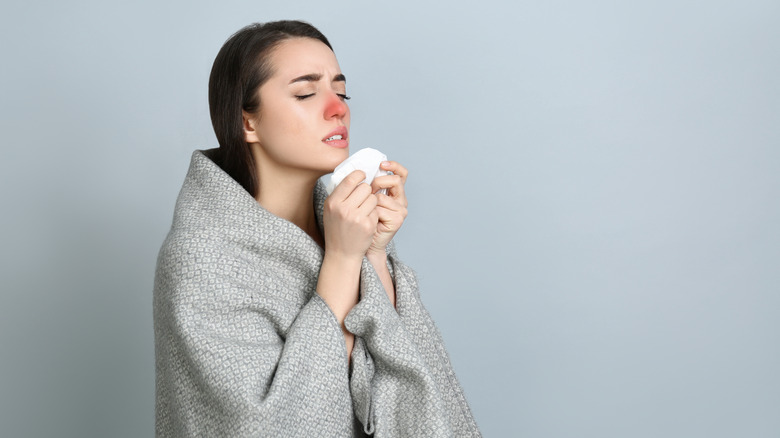 A woman has a cold and can't smell