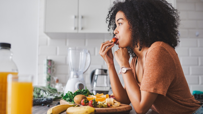 Woman eating a fruit salad