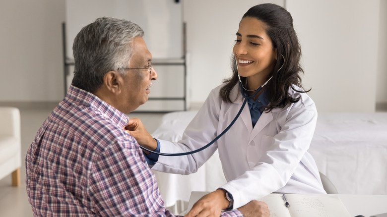 Elderly man talking to his doctor