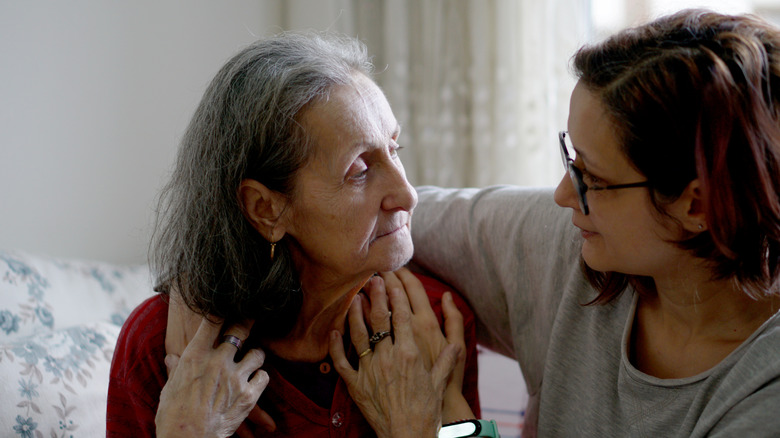 Woman hugging her elderly mother