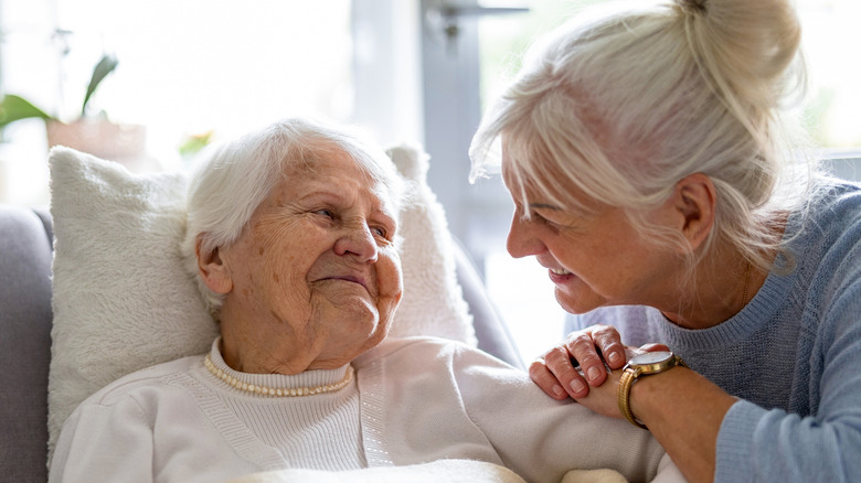 Elderly woman with a loving family member