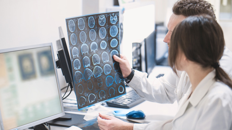 Doctors looking at a patient's X-ray