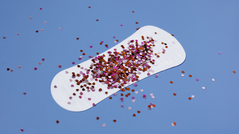 Pad on blue background with red glitter on resembling blood