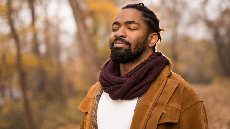 Man in woods smiling